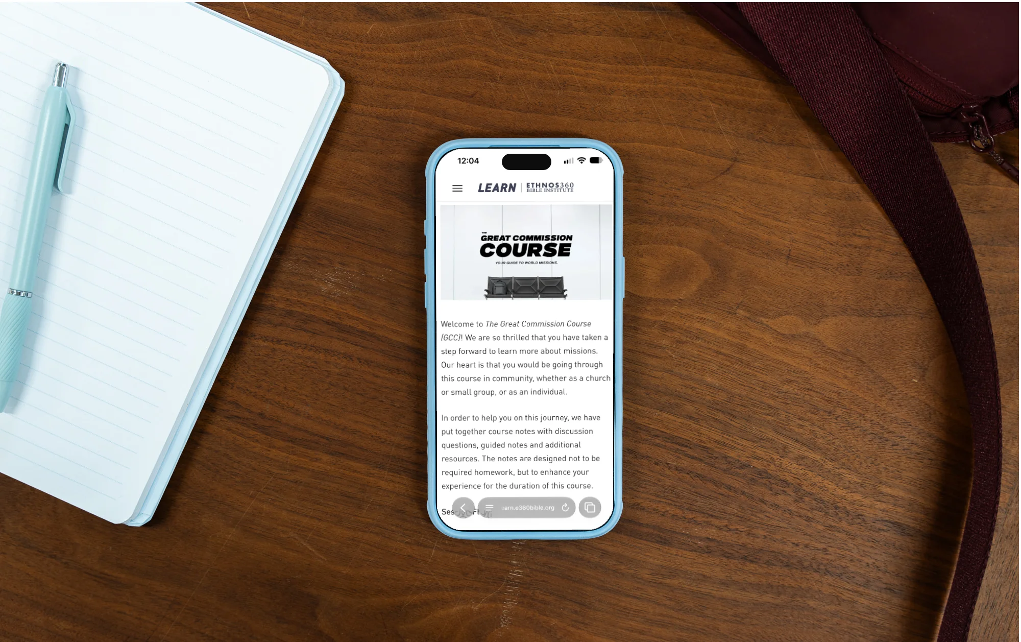 Phone on desk showing Great Commission Course